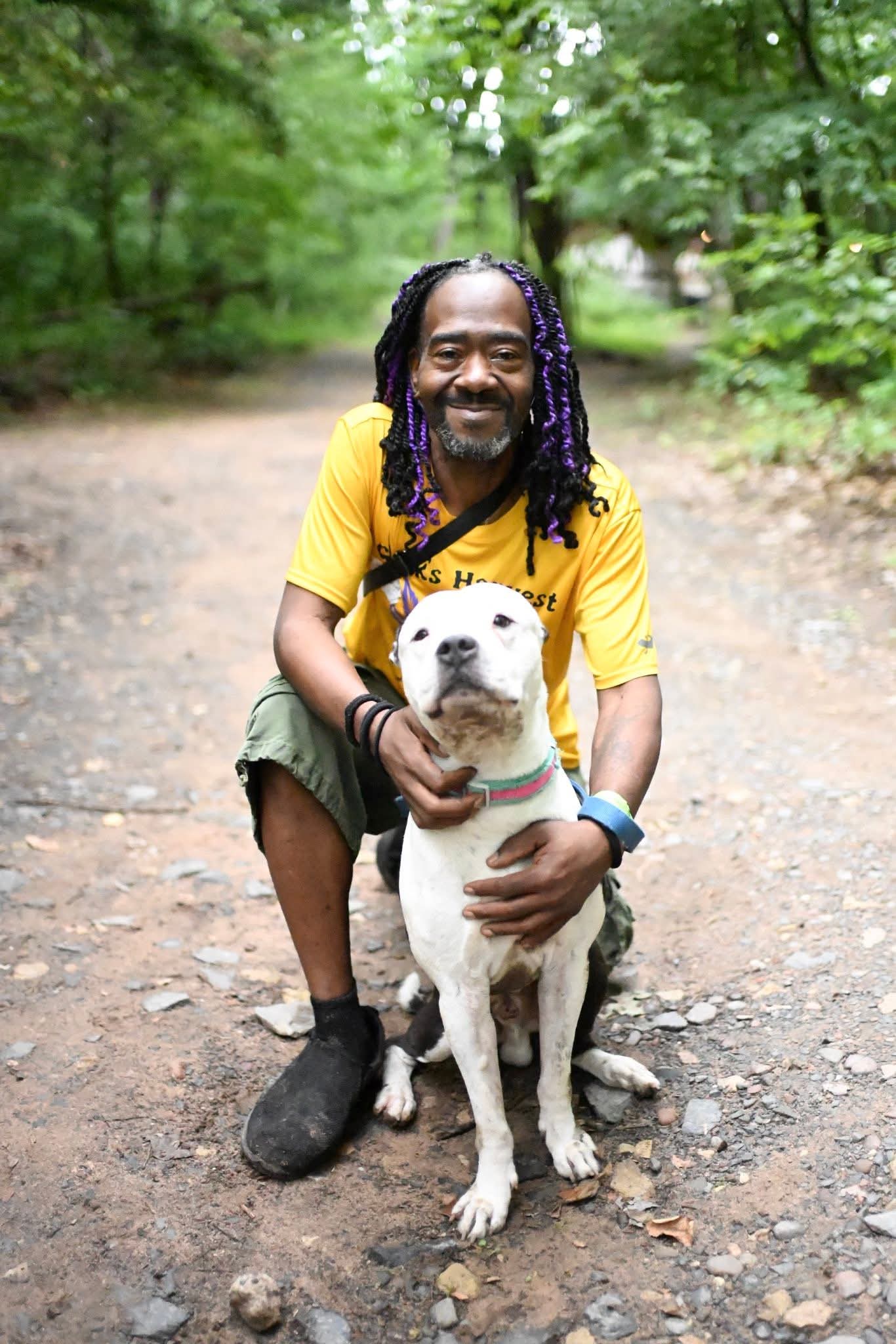 Community member on nature trail with dog