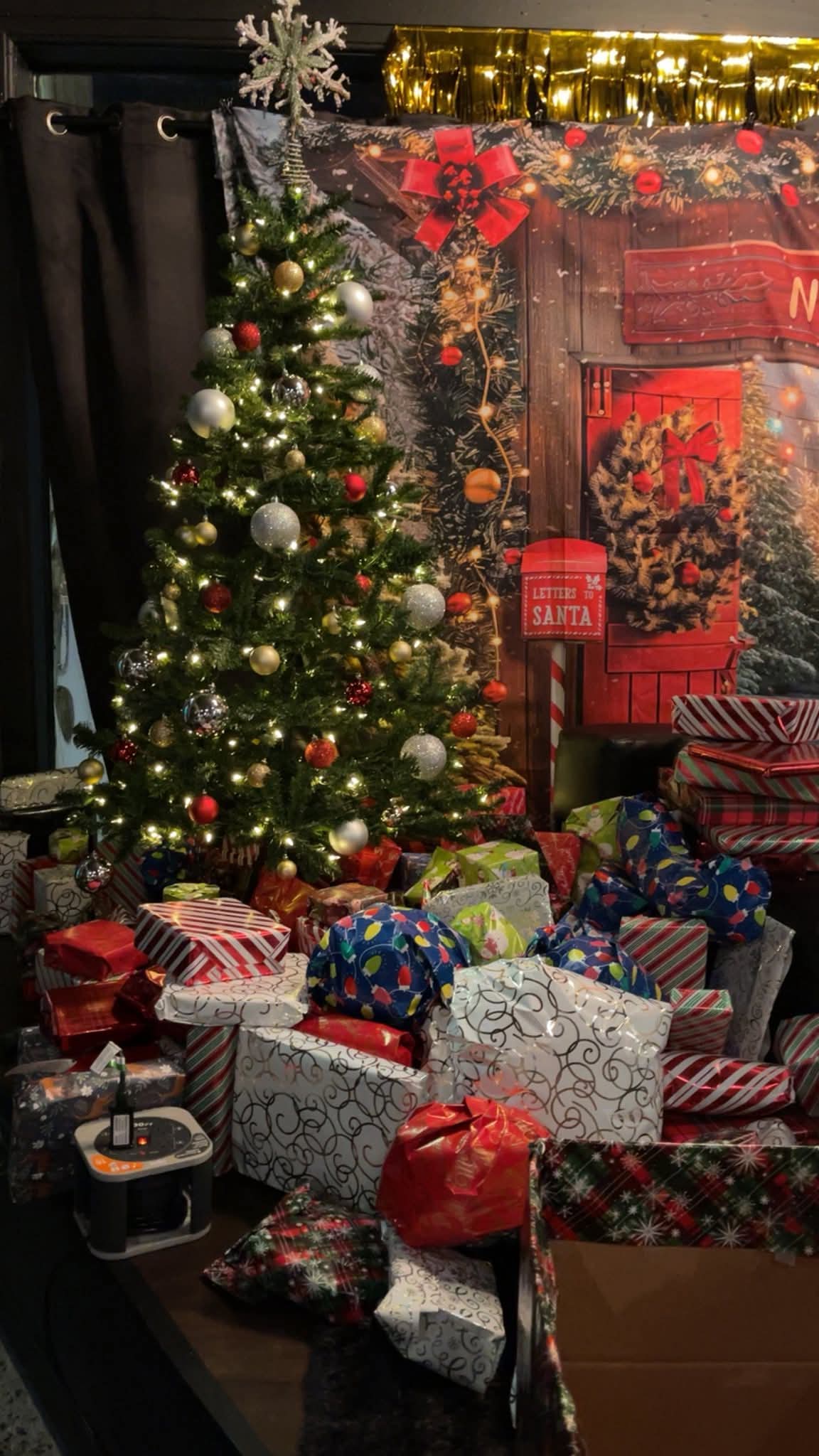 Holiday gift drive presents under the tree